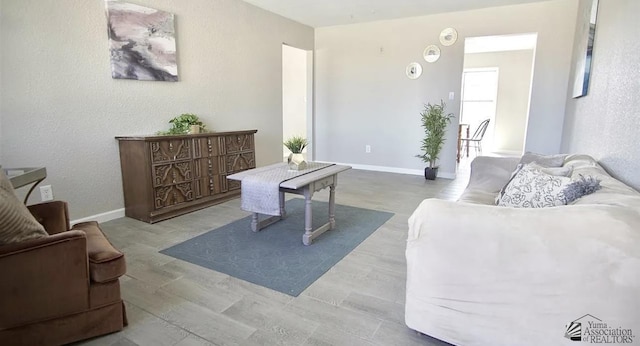 living area featuring baseboards