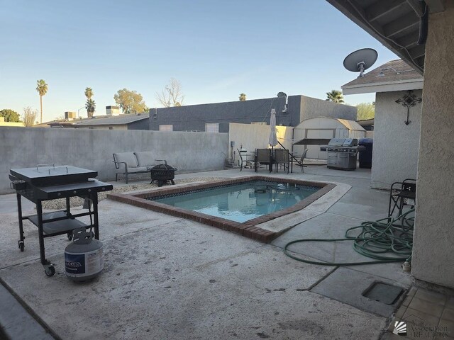 1957 Athens Ave, Yuma, AZ 85364 - view of swimming pool with fence, an outdoor fire pit, and a patio area