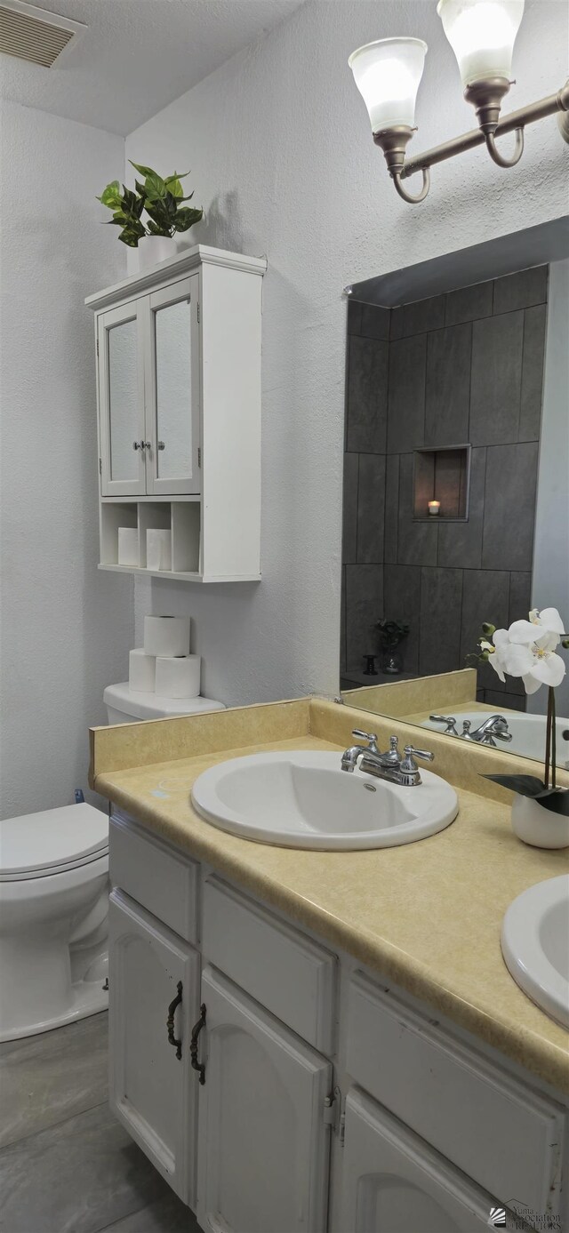 1957 Athens Ave, Yuma, AZ 85364 - bathroom featuring double vanity, visible vents, a sink, and a fireplace