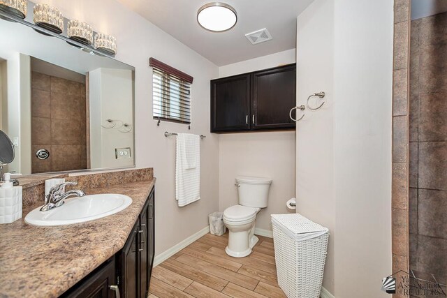 10120 S Galaxy Ave, Yuma, AZ 85367 - full bathroom featuring visible vents, vanity, wood finished floors, toilet, and baseboards