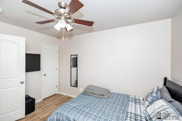 10120 S Galaxy Ave, Yuma, AZ 85367 - bedroom with light wood-style floors, baseboards, and ceiling fan