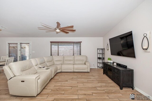 10120 S Galaxy Ave, Yuma, AZ 85367 - living area with light wood-style floors, a ceiling fan, a wealth of natural light, and visible vents