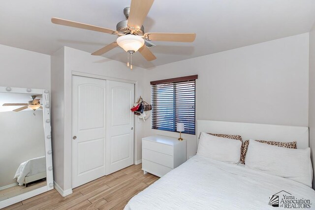 10120 S Galaxy Ave, Yuma, AZ 85367 - bedroom with light wood-style floors, a ceiling fan, baseboards, and a closet