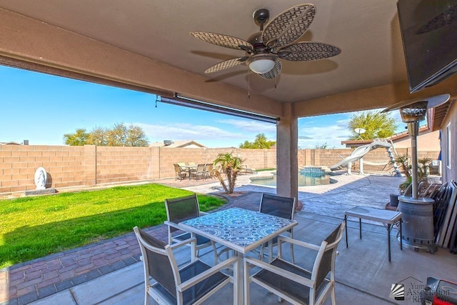 10120 S Galaxy Ave, Yuma, AZ 85367 - view of patio with ceiling fan, a fenced in pool, outdoor dining space, and a fenced backyard