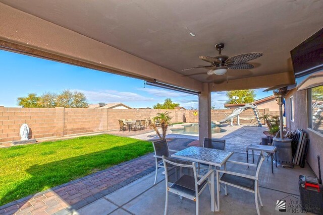 10120 S Galaxy Ave, Yuma, AZ 85367 - view of patio featuring a fenced backyard, a fenced in pool, outdoor dining space, and ceiling fan