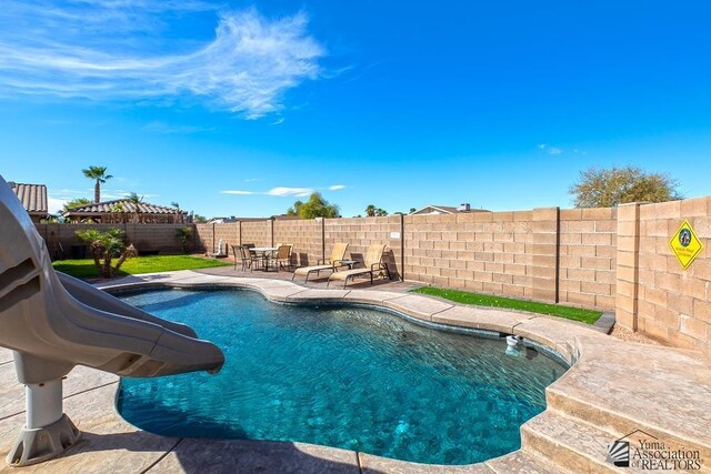 10120 S Galaxy Ave, Yuma, AZ 85367 - view of swimming pool featuring a fenced in pool, a fenced backyard, a water slide, and a patio
