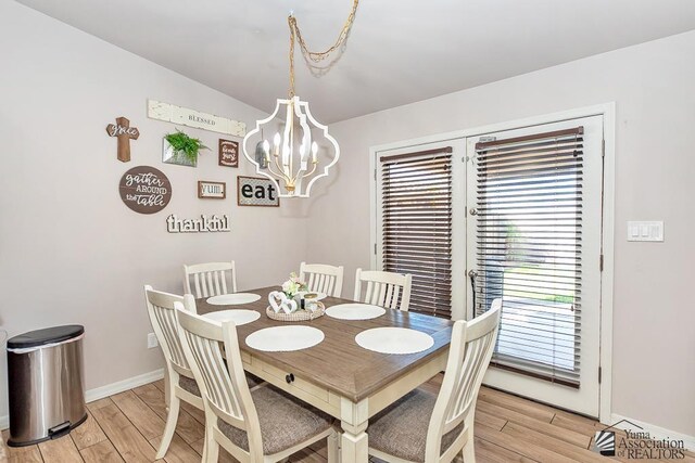 10120 S Galaxy Ave, Yuma, AZ 85367 - dining area featuring baseboards, a chandelier, and light wood finished floors