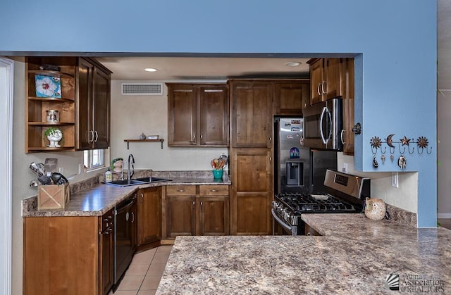 285 E 26th St, Yuma, AZ 85364 - kitchen with appliances with stainless steel finishes, open shelves, light tile patterned flooring, a peninsula, and recessed lighting