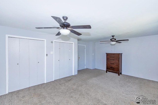 285 E 26th St, Yuma, AZ 85364 - unfurnished bedroom with light carpet, multiple closets, and a ceiling fan