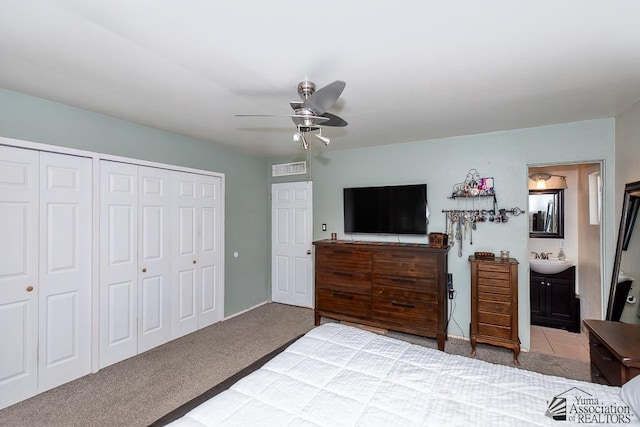 285 E 26th St, Yuma, AZ 85364 - carpeted bedroom featuring two closets, a ceiling fan, and ensuite bath