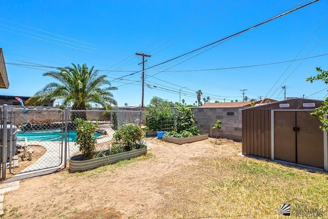 285 E 26th St, Yuma, AZ 85364 - view of yard featuring a storage unit and a vegetable garden