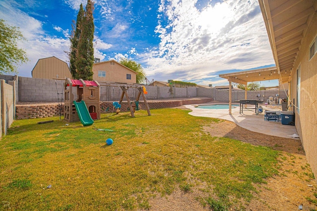 view of yard featuring a fenced backyard, a patio area, and a playground