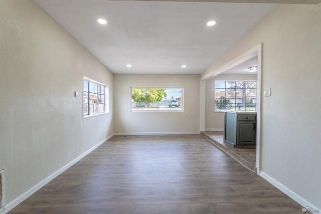 unfurnished room with recessed lighting, dark wood-style flooring, and baseboards
