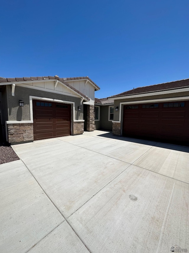 12310 S Aloa Ln, Yuma, AZ 85367 - view of front facade with an attached garage, driveway, and stone siding