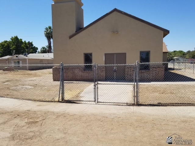 2117 N H Street 2117H Street, Winterhaven, CA 92283 - view of side of property with a gate, stucco siding, and fence
