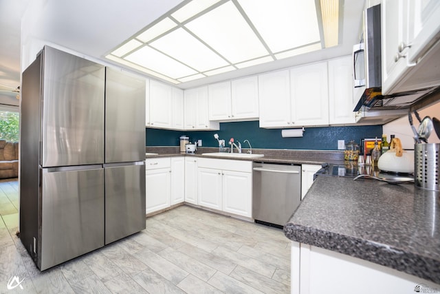 2231 S Elks Ln # 67, Yuma, AZ 85364 - kitchen with stainless steel appliances, a sink, dark countertops, and white cabinets