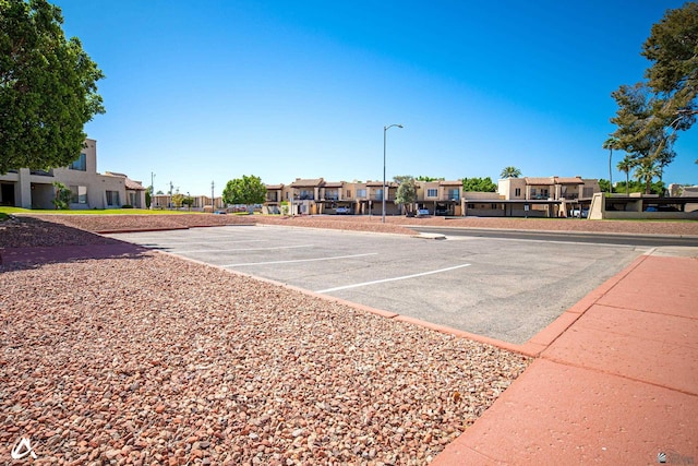 2231 S Elks Ln # 67, Yuma, AZ 85364 - uncovered parking lot featuring a residential view