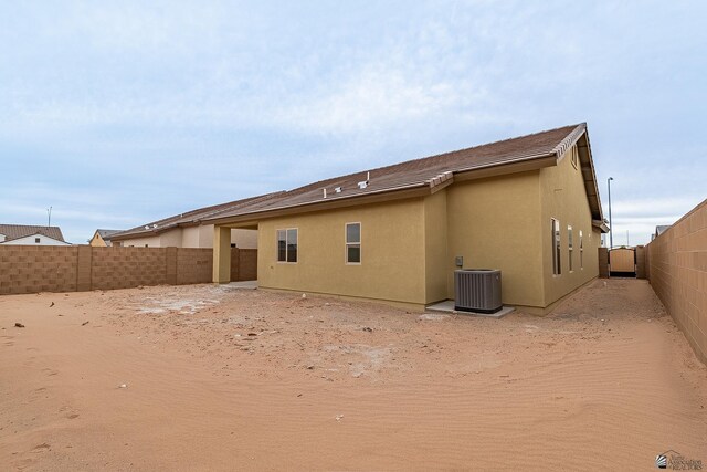 7972 E 34th Ln, Yuma, AZ 85365 - back of property with cooling unit, a fenced backyard, and stucco siding