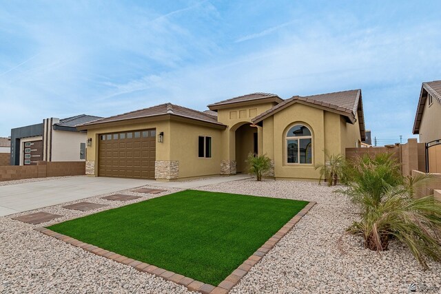 7972 E 34th Ln, Yuma, AZ 85365 - mediterranean / spanish-style home with fence, a garage, stucco siding, a front yard, and driveway