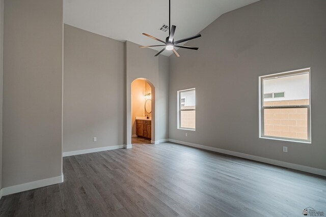 7972 E 34th Ln, Yuma, AZ 85365 - unfurnished room with ceiling fan, arched walkways, wood finished floors, baseboards, and high vaulted ceiling