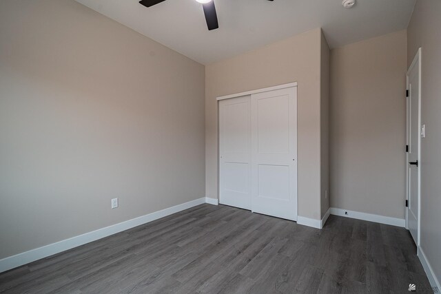 7972 E 34th Ln, Yuma, AZ 85365 - unfurnished bedroom with baseboards, a closet, and dark wood finished floors
