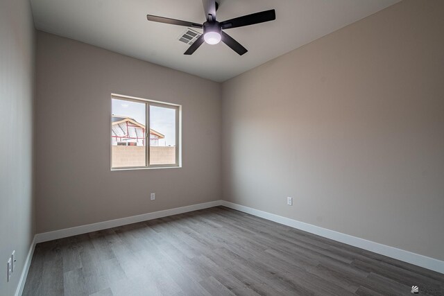 7972 E 34th Ln, Yuma, AZ 85365 - empty room featuring baseboards, a ceiling fan, dark wood finished floors, and visible vents