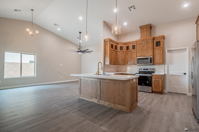 7972 E 34th Ln, Yuma, AZ 85365 - kitchen with visible vents, high vaulted ceiling, light countertops, a sink, and appliances with stainless steel finishes