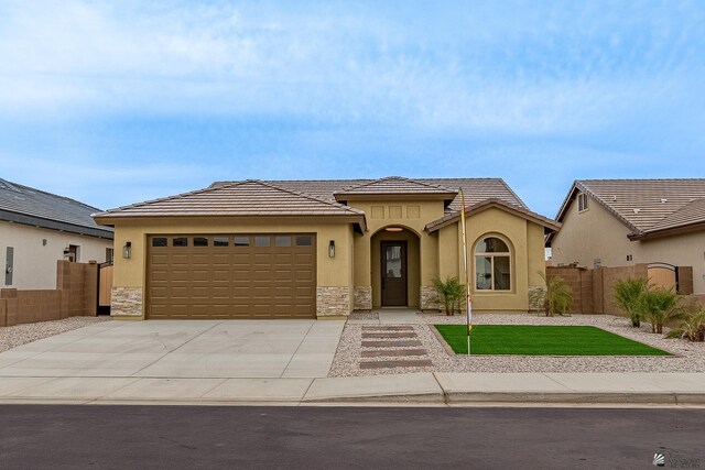 7972 E 34th Ln, Yuma, AZ 85365 - view of front of home with an attached garage, fence, stone siding, and stucco siding