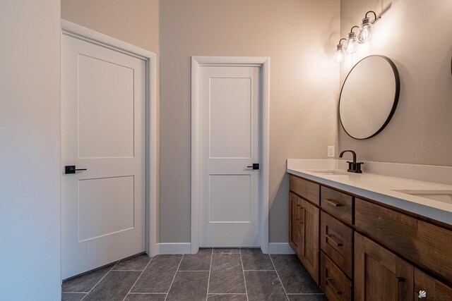 7972 E 34th Ln, Yuma, AZ 85365 - full bathroom with double vanity, baseboards, and a sink