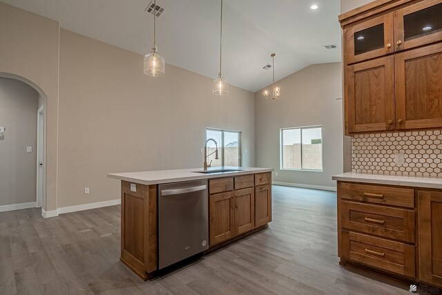 7972 E 34th Ln, Yuma, AZ 85365 - kitchen with a sink, dishwasher, arched walkways, brown cabinetry, and visible vents