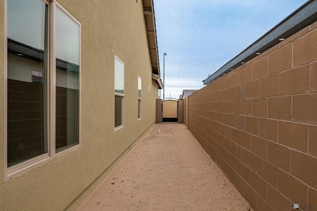 7972 E 34th Ln, Yuma, AZ 85365 - view of side of property featuring fence, a gate, and stucco siding