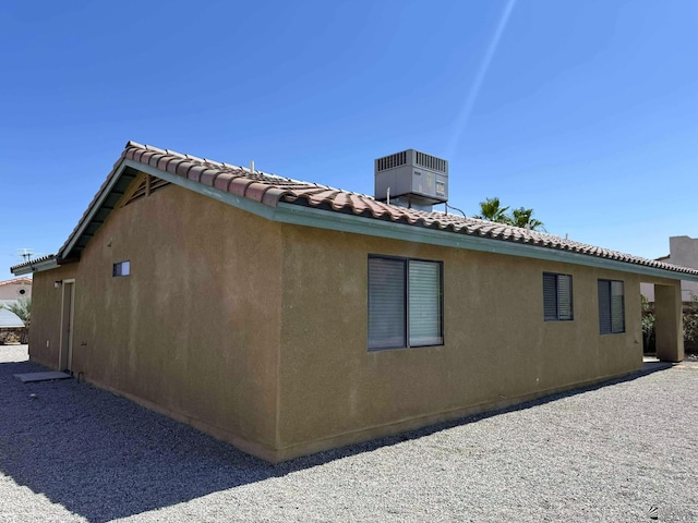 14713 E 52nd Dr, Yuma, AZ 85367 - view of side of property with central AC, a tile roof, and stucco siding