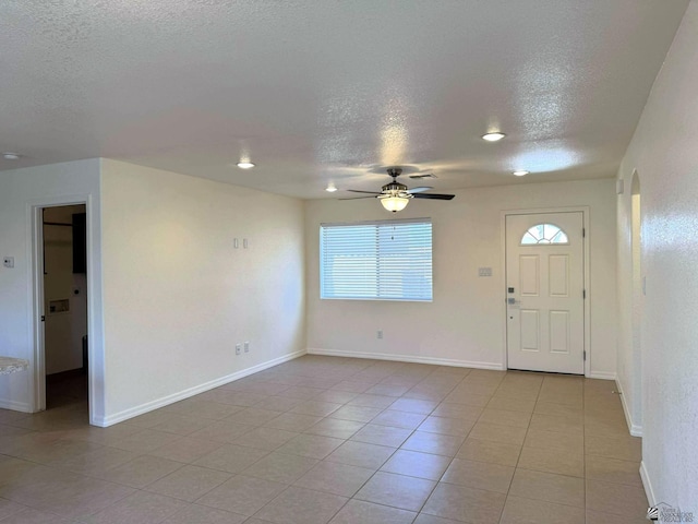 14713 E 52nd Dr, Yuma, AZ 85367 - foyer entrance with a textured ceiling, ceiling fan, light tile patterned floors, and baseboards