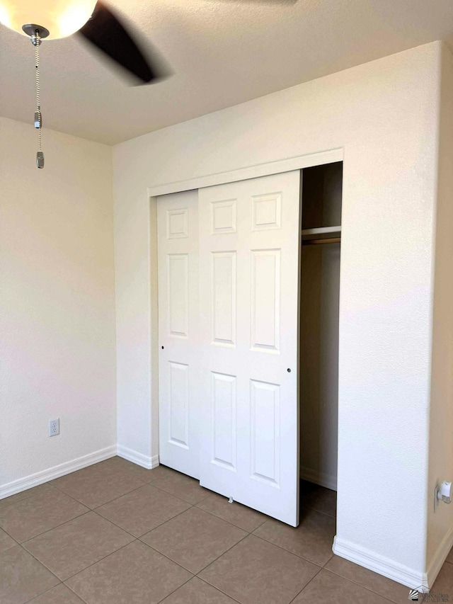 14713 E 52nd Dr, Yuma, AZ 85367 - unfurnished bedroom with a closet, tile patterned floors, baseboards, and ceiling fan