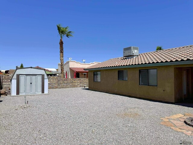 14713 E 52nd Dr, Yuma, AZ 85367 - back of property with central air condition unit, a tiled roof, and stucco siding