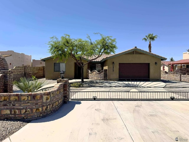 14713 E 52nd Dr, Yuma, AZ 85367 - view of front facade featuring an attached garage, stucco siding, a gate, a tiled roof, and driveway