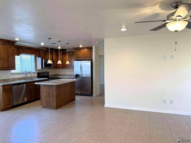 14713 E 52nd Dr, Yuma, AZ 85367 - kitchen with appliances with stainless steel finishes, baseboards, a kitchen island, ceiling fan, and recessed lighting