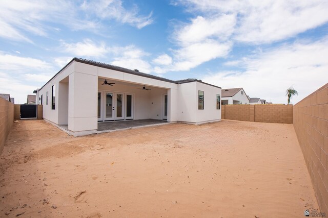 view of side of home featuring a fenced backyard and stucco siding