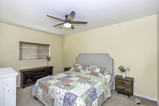 bedroom featuring a ceiling fan, light colored carpet, visible vents, and baseboards