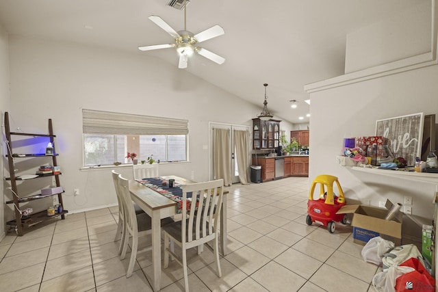 dining space with ceiling fan, vaulted ceiling, light tile patterned flooring, and visible vents