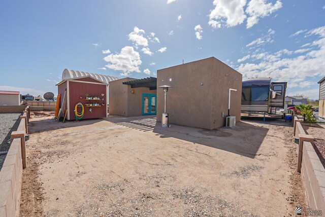 rear view of house with stucco siding