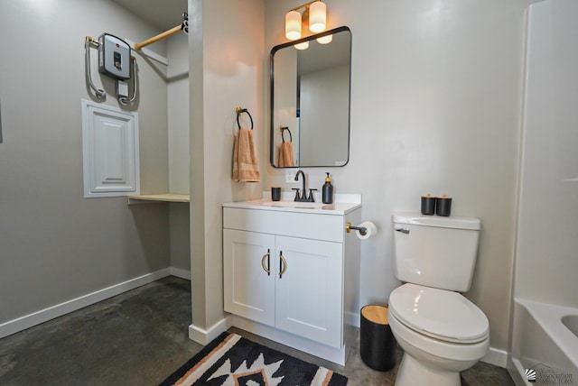 bathroom with vanity, concrete floors, baseboards, and toilet