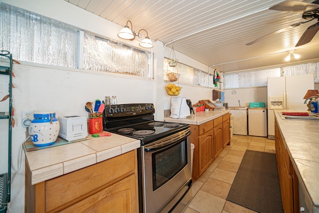 13252 E 54th Dr, Yuma, AZ 85367 - kitchen featuring stainless steel electric stove, light tile patterned floors, and plenty of natural light