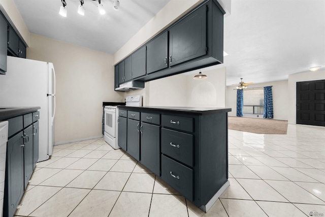 2155 S 14th Ave # 36, Yuma, AZ 85364 - kitchen with light tile patterned floors, a ceiling fan, open floor plan, baseboards, and white appliances