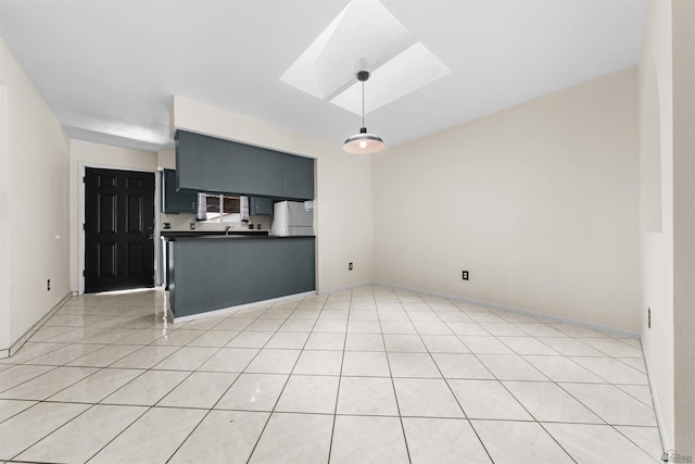2155 S 14th Ave # 36, Yuma, AZ 85364 - kitchen featuring light tile patterned floors, freestanding refrigerator, dark countertops, a skylight, and decorative light fixtures