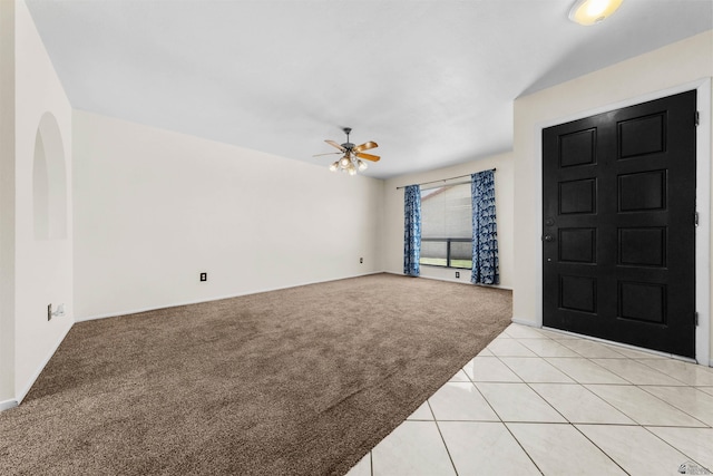 2155 S 14th Ave # 36, Yuma, AZ 85364 - foyer with a ceiling fan, light carpet, light tile patterned floors, and baseboards