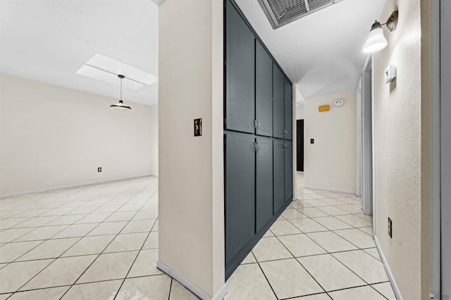 2155 S 14th Ave # 36, Yuma, AZ 85364 - hallway featuring a skylight, light tile patterned floors, and baseboards
