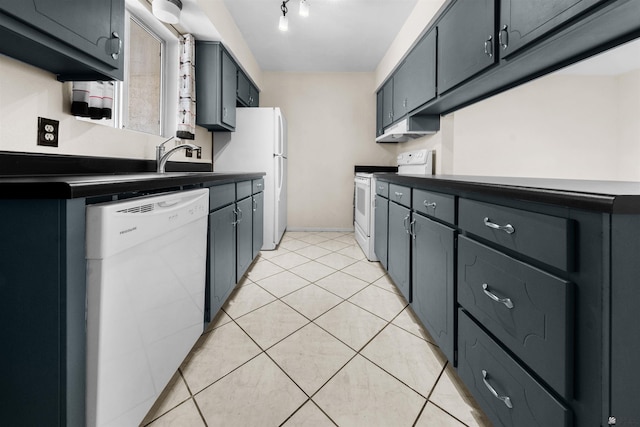 2155 S 14th Ave # 36, Yuma, AZ 85364 - kitchen featuring white appliances, light tile patterned floors, dark countertops, and a sink