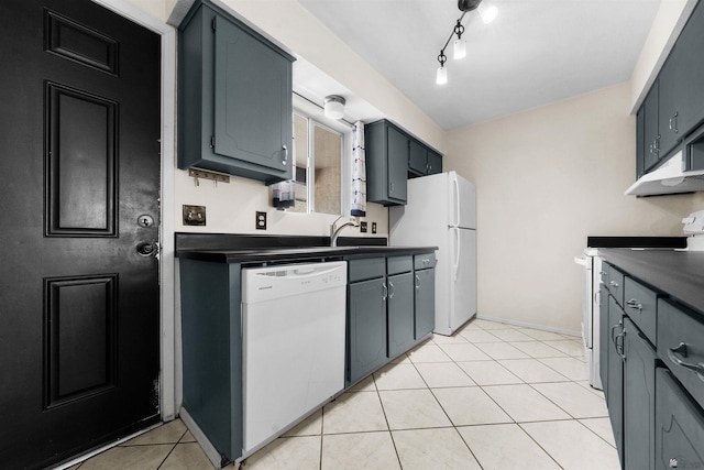2155 S 14th Ave # 36, Yuma, AZ 85364 - kitchen featuring light tile patterned floors, white appliances, dark countertops, and under cabinet range hood