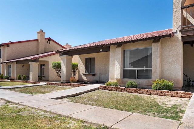2155 S 14th Ave # 36, Yuma, AZ 85364 - view of front of house featuring stucco siding, a tile roof, and a front yard